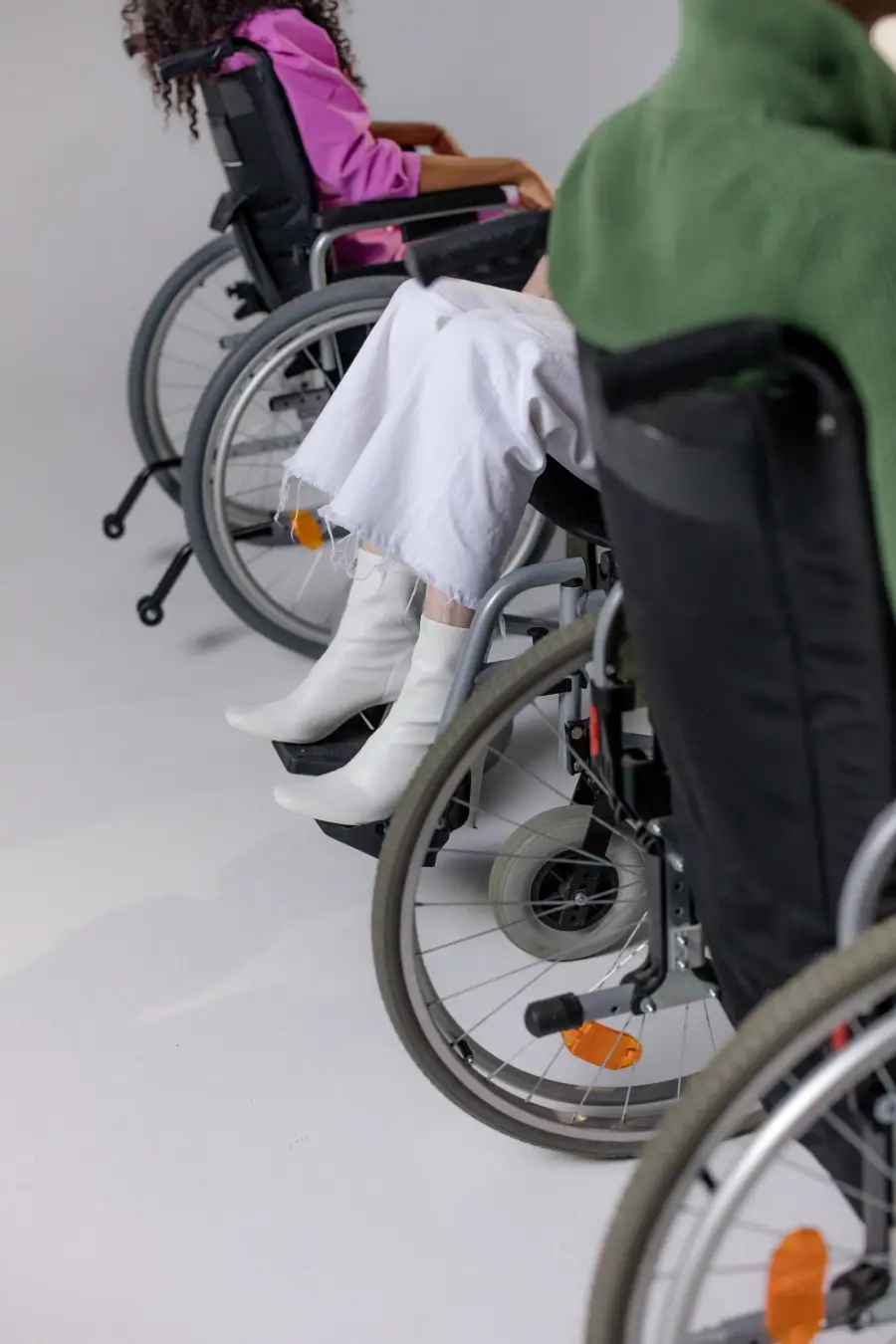 Two people in wheelchairs side by side